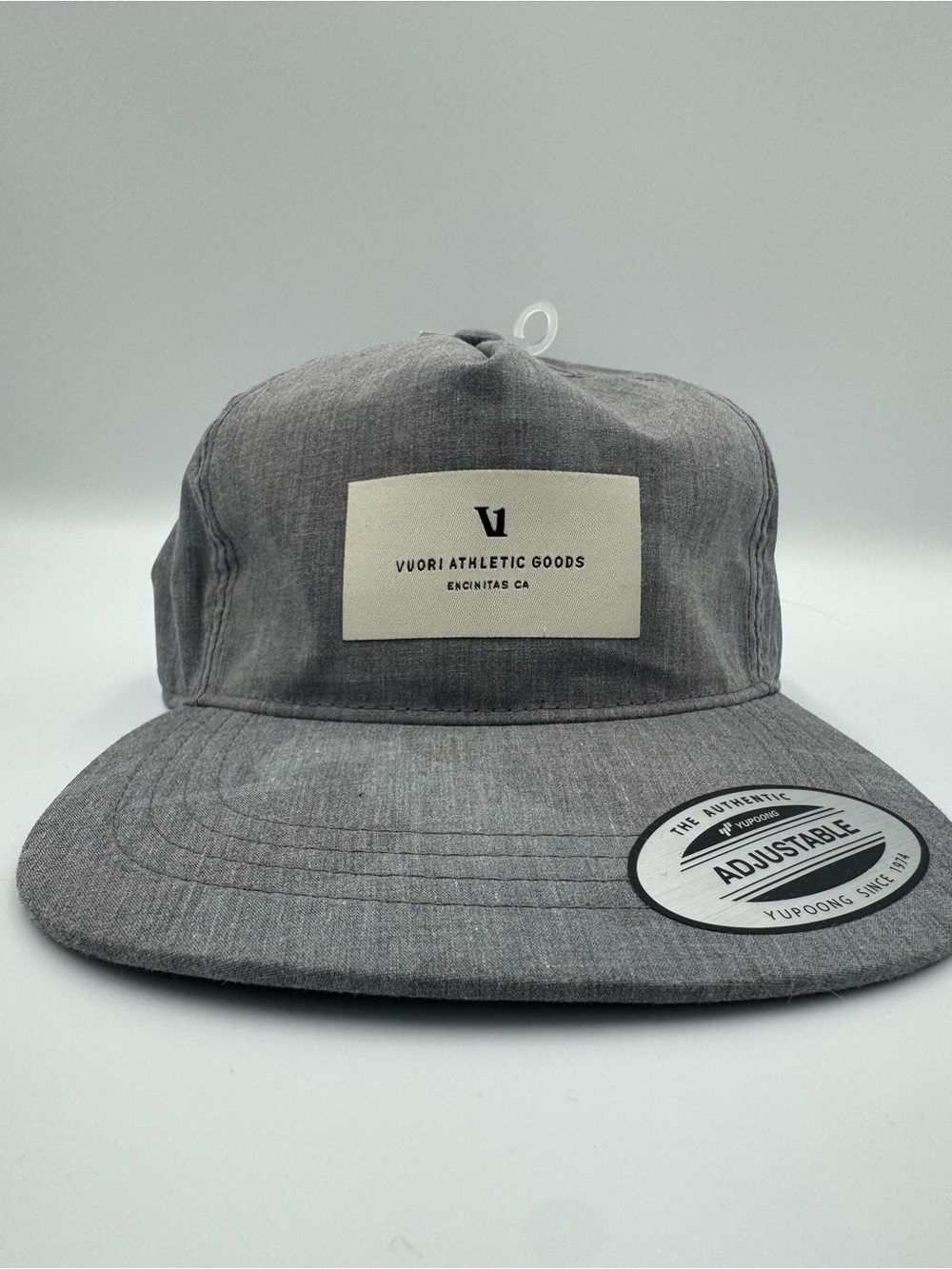 Vuori Gray Five-Panel Adjustable Cap/ Front Patch with faint camo design on brim